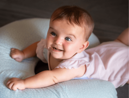 bebê sobre um travesseiro antirrefluxo branco